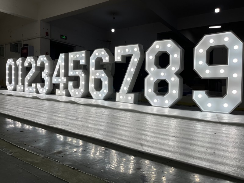 Marquee numbers 0 to 9 lit against a dark backdrop