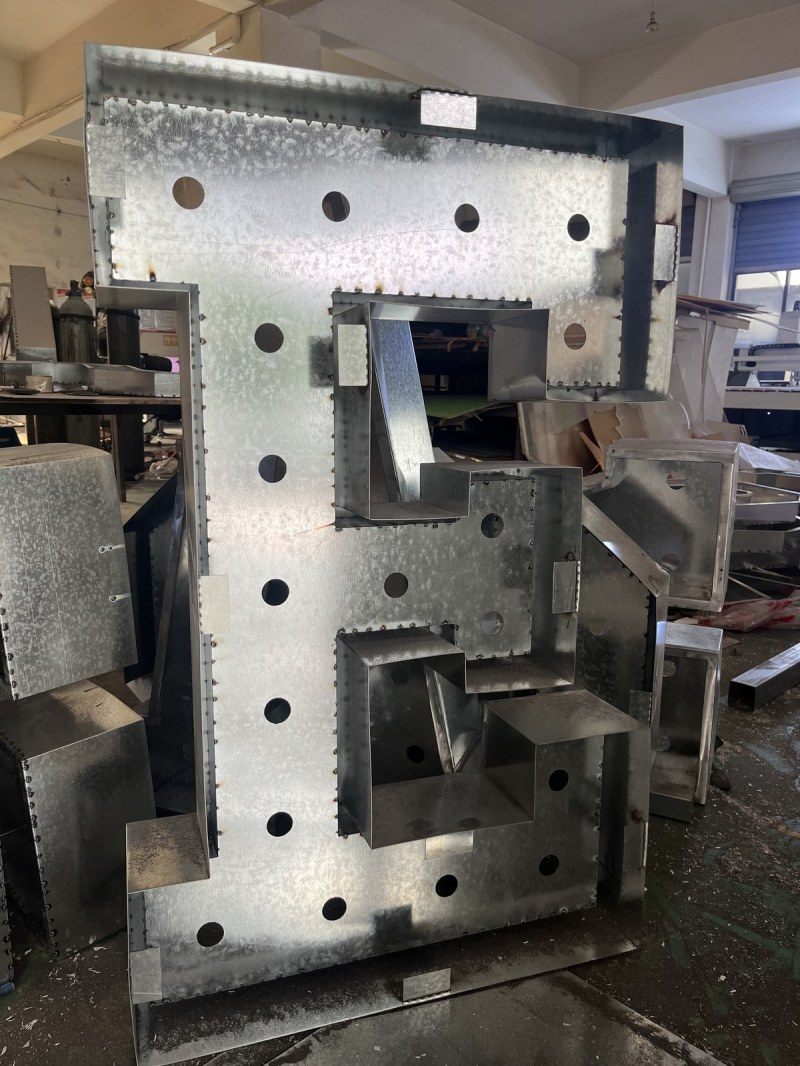 A letter frame before the face panel is fitted, showing the welded internal braces